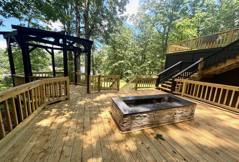 Wooden deck featuring an outdoor fire pit, stairs, and a gazebo
