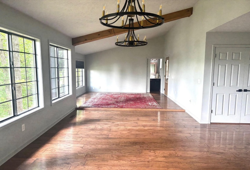Unfurnished dining area featuring a chandelier, plenty of natural light, and baseboards