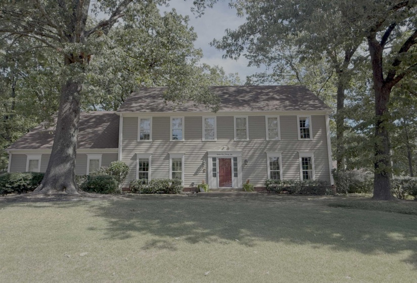 Colonial home with a front yard