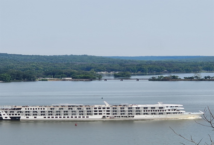 Water view with a heavily wooded area