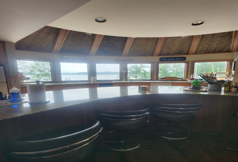Bar area with healthy amount of natural light, recessed lighting, and a sink