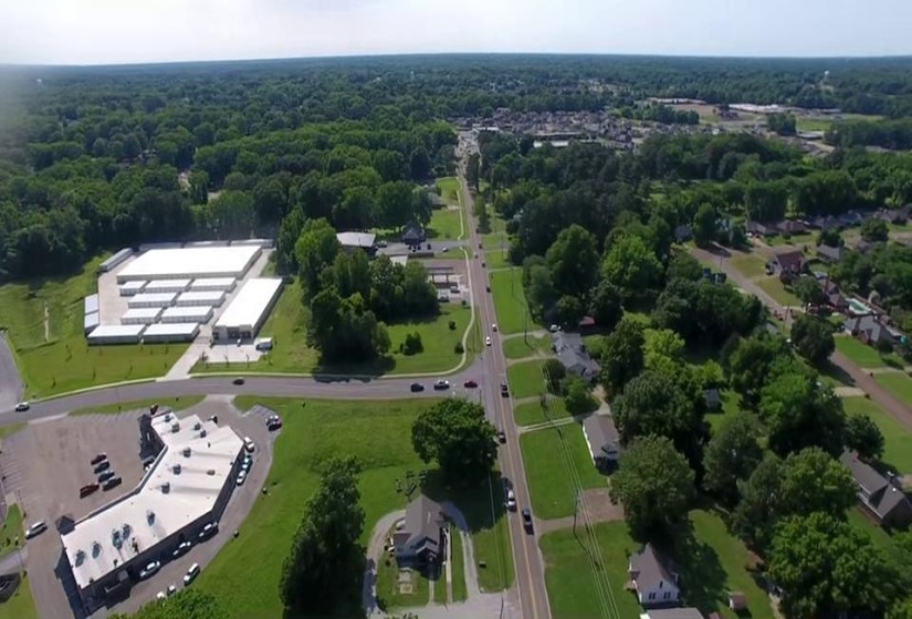 Aerial view of property and surrounding area featuring a heavily wooded area