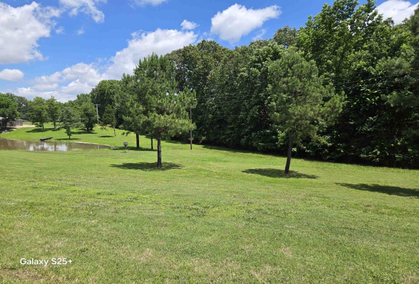 Surrounding community featuring a water view and a lawn