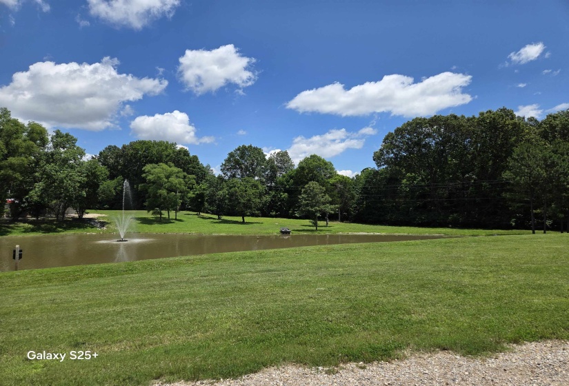 View of property's community featuring a yard and a water view