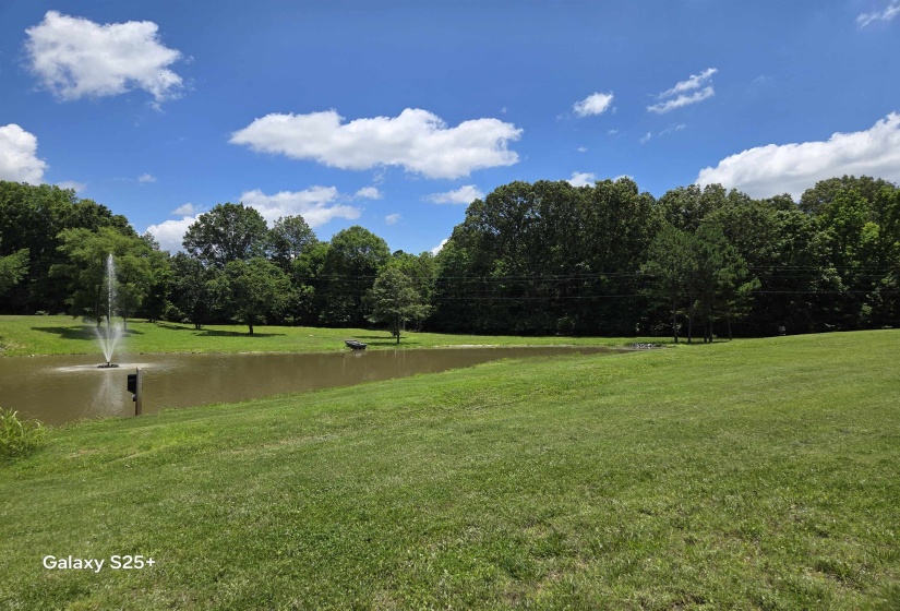 View of home's community with a yard and a water view