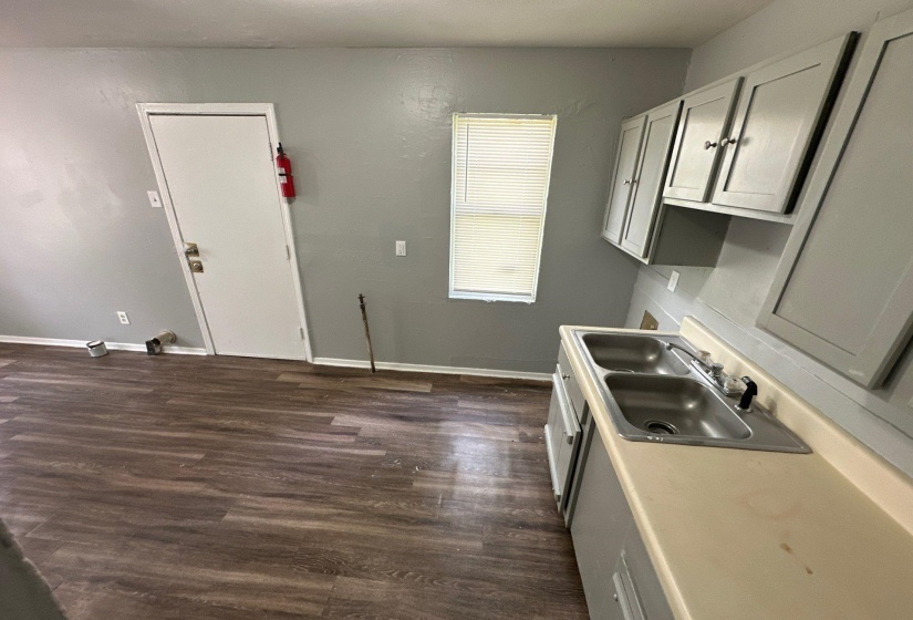 Kitchen with dark hardwood / wood-style floors, sink, and gray cabinets