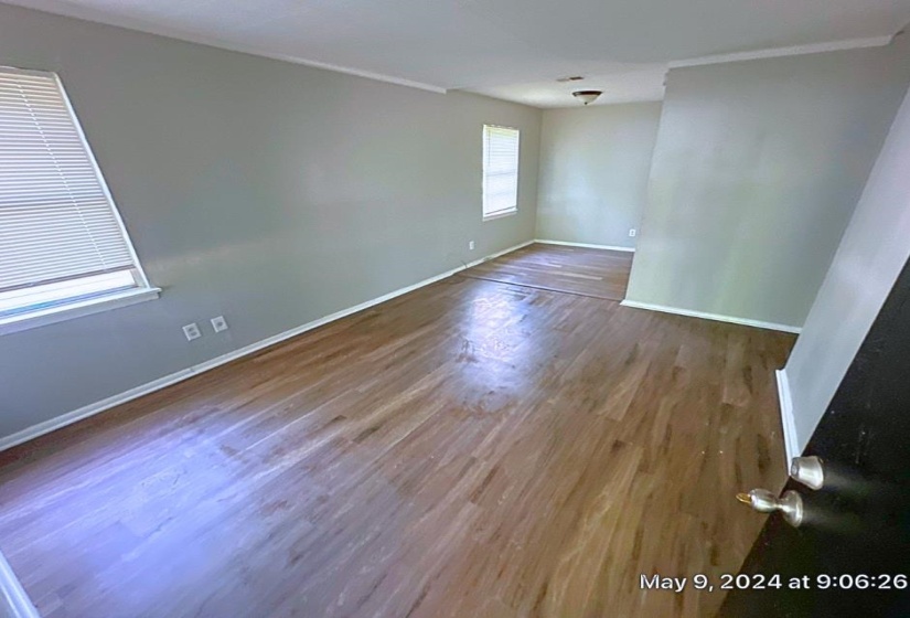 Spare room with crown molding and hardwood / wood-style floors