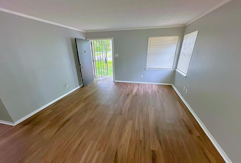 Empty room featuring crown molding and hardwood / wood-style flooring