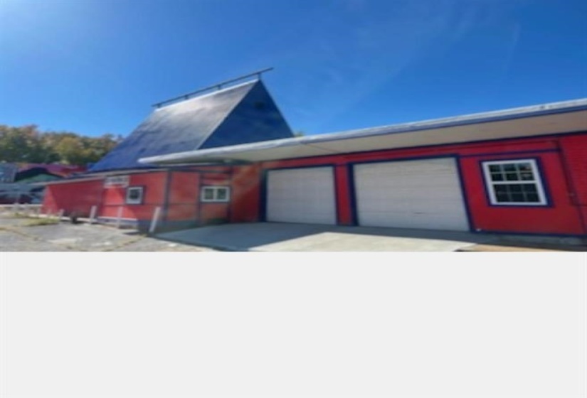 View of home's exterior featuring a garage and driveway