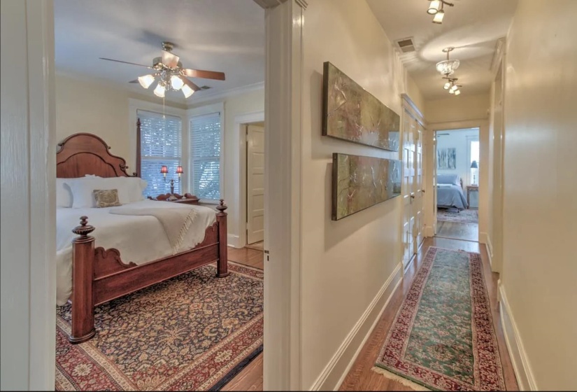 Bedroom with wood finished floors, ceiling fan, and baseboards