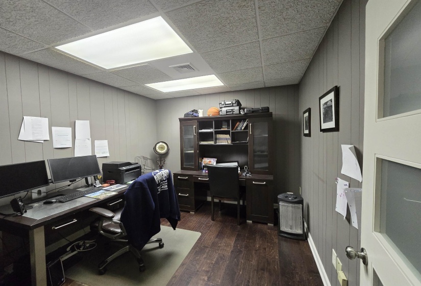 Office featuring wood finished floors and a drop ceiling