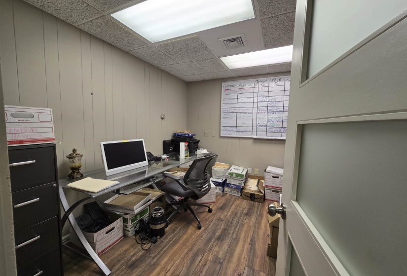 Office featuring wood finished floors and a paneled ceiling