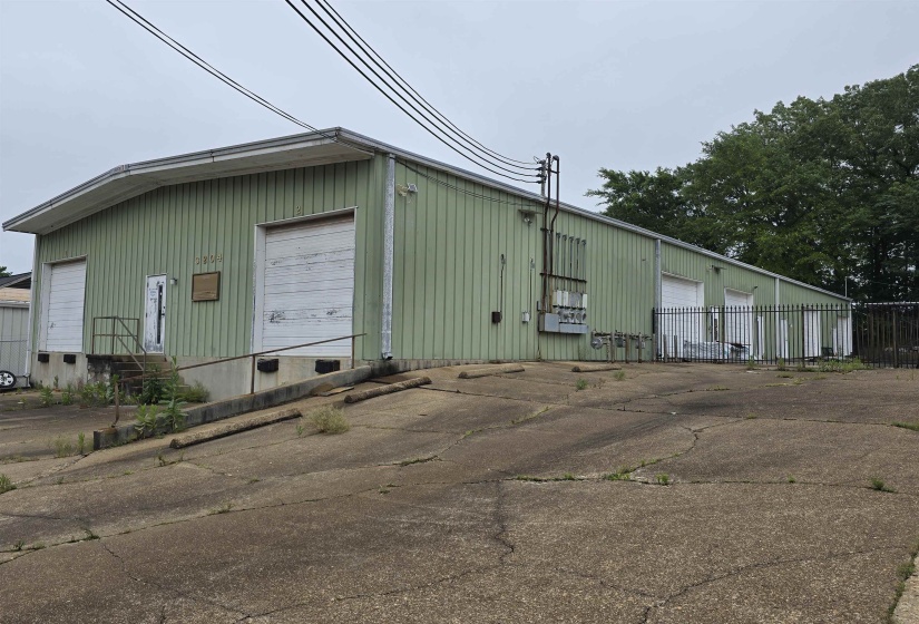 View of property featuring a detached garage and entry steps