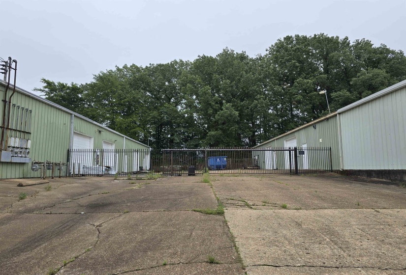 View of parking / parking lot with a garage