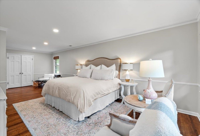 Bedroom featuring ornamental molding, recessed lighting, wood finished floors, and baseboards