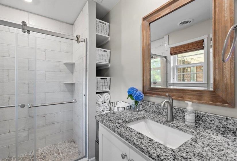 Bathroom featuring vanity and a stall shower