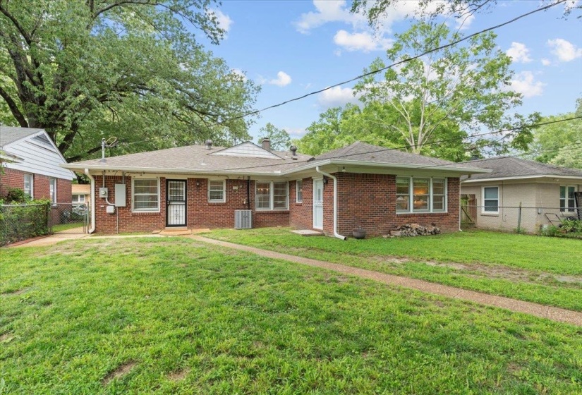 Ranch-style home with brick siding, a chimney, and central AC