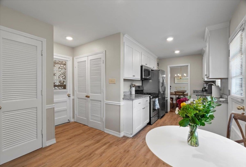 Kitchen featuring appliances with stainless steel finishes, white cabinets, light wood finished floors, recessed lighting, and baseboards