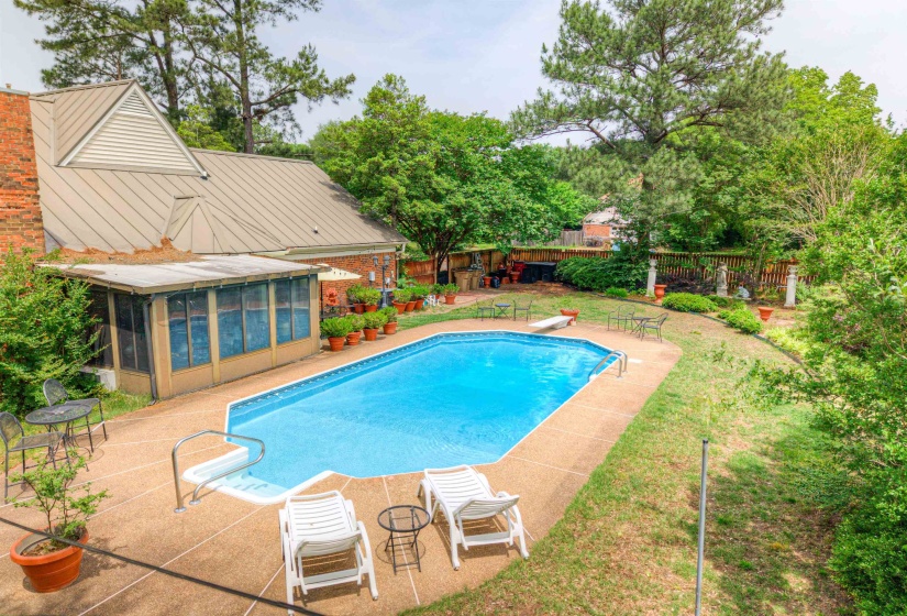 View of swimming pool featuring a sunroom, a patio area, and a diving board