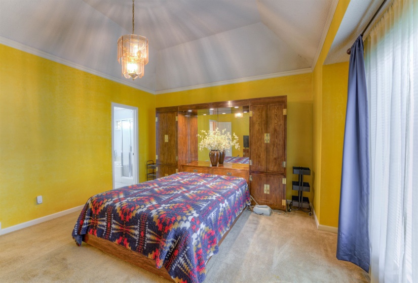 Bedroom with carpet, baseboards, ornamental molding, and connected bathroom