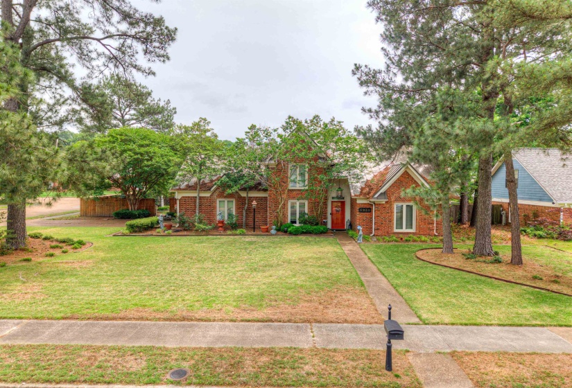 View of front facade featuring a front lawn and brick siding