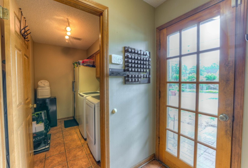 Washroom featuring cabinet space, washing machine and clothes dryer, tile patterned flooring, and a textured ceiling