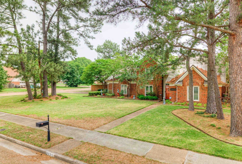 View of front of property featuring a front lawn and brick siding