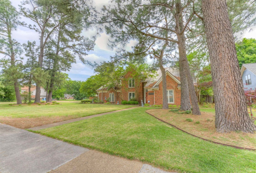 View of front of property with a front yard and brick siding