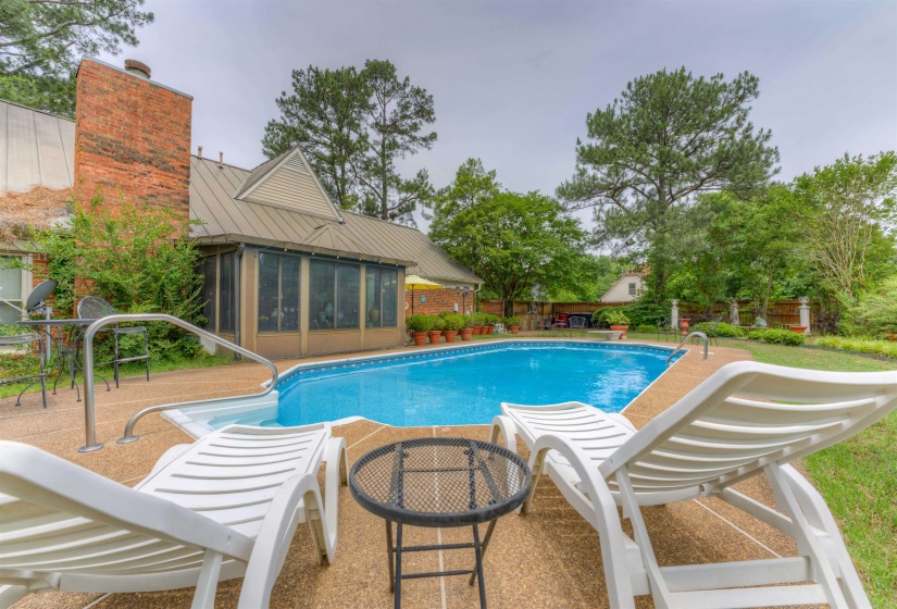 View of pool with a sunroom and a patio