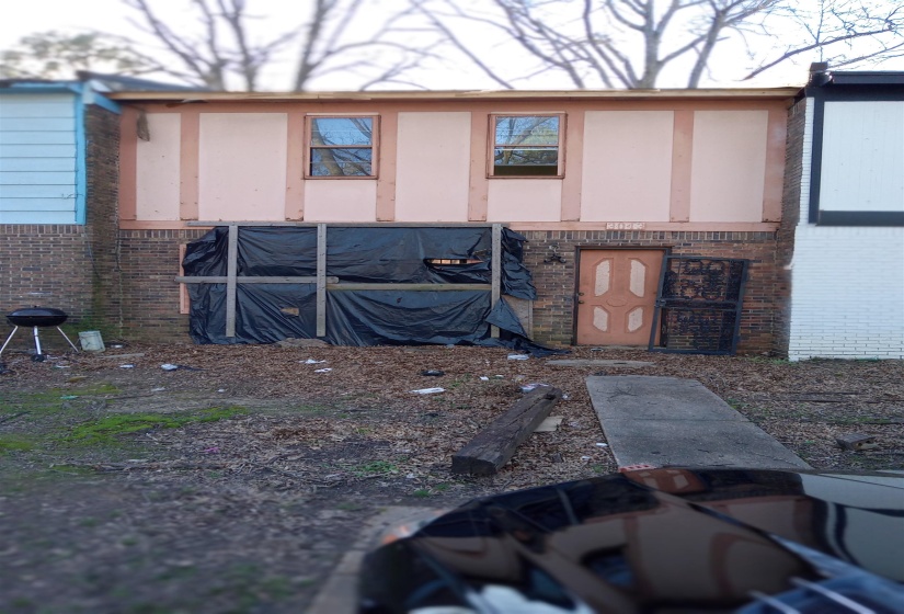Back of property with brick siding