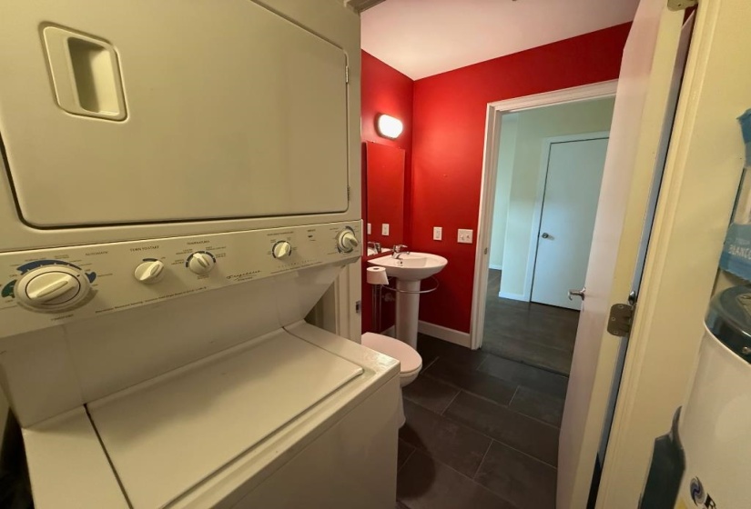 Bathroom featuring stacked washer / drying machine and tile patterned flooring