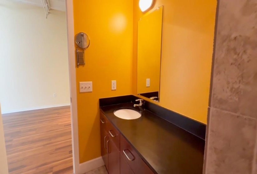 Bathroom featuring vanity and wood finished floors