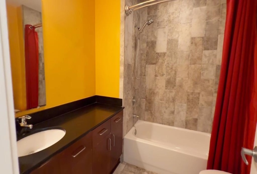 Bathroom featuring vanity and shower / tub combo