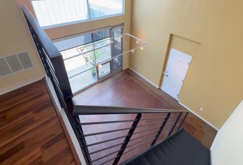 Staircase featuring baseboards and a high ceiling
