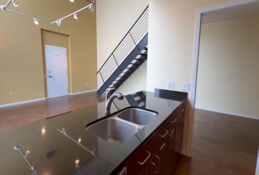 Kitchen with a sink and dark countertops