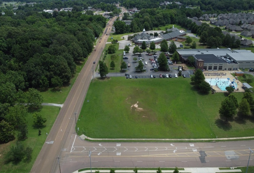 View of property location with a pool area and a main thoroughfare