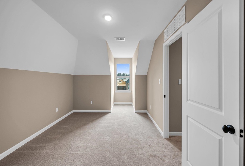 Bonus room featuring baseboards, visible vents, and light colored carpet