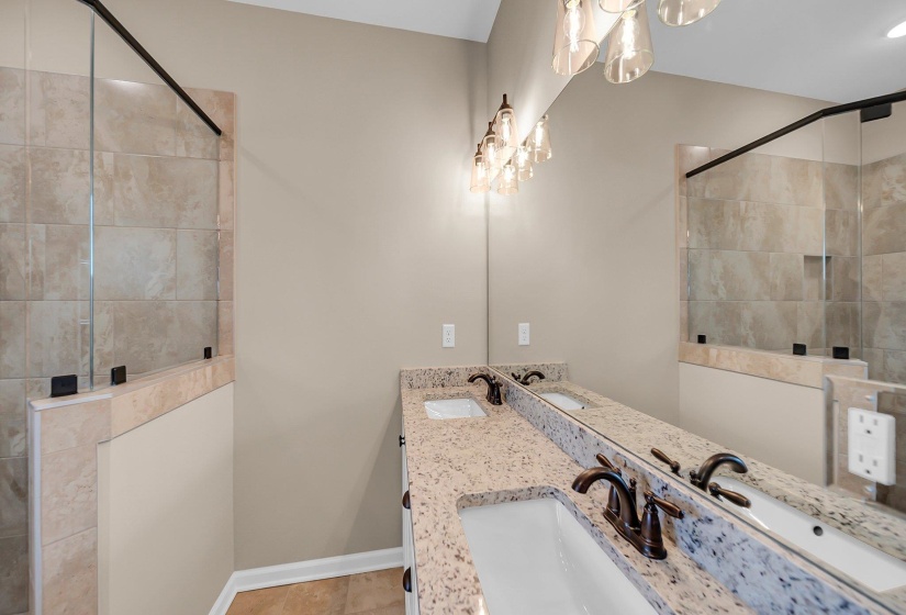 Full bathroom with a tile shower and a sink