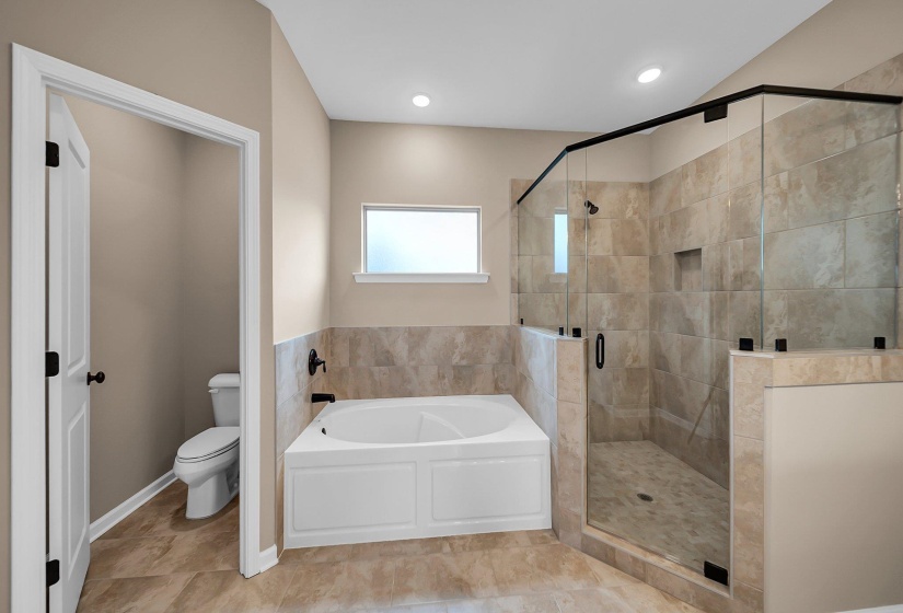 Bathroom with toilet, a shower stall, a bath, and recessed lighting