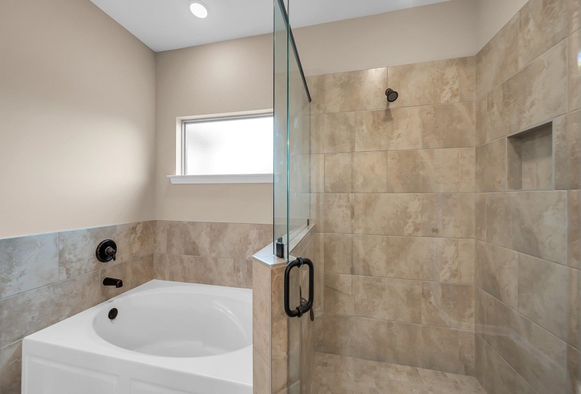 Bathroom featuring a stall shower and a bath
