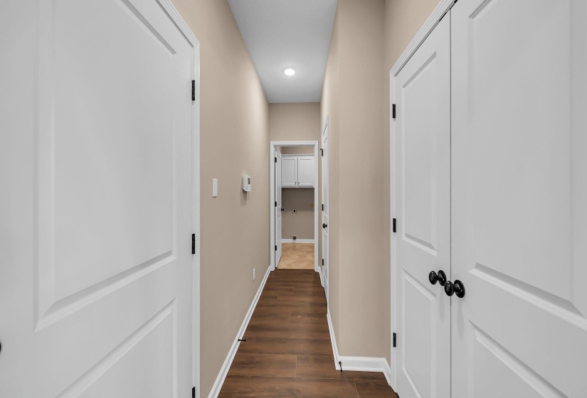 Corridor with baseboards, dark wood-style flooring, and recessed lighting