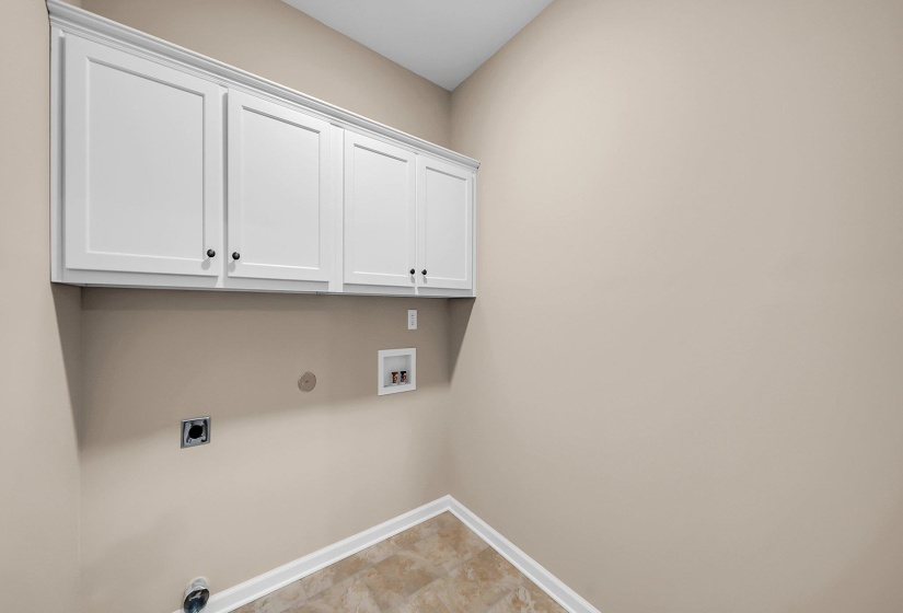 Laundry area featuring gas dryer hookup, hookup for an electric dryer, washer hookup, baseboards, and cabinet space