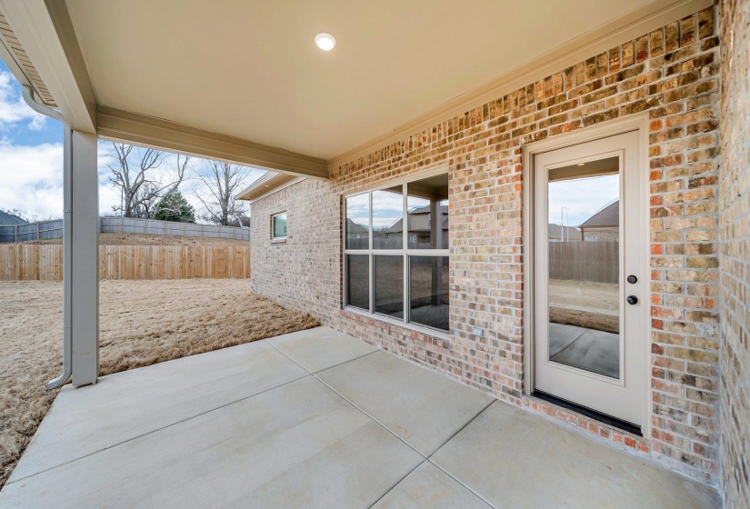 View of patio featuring fence