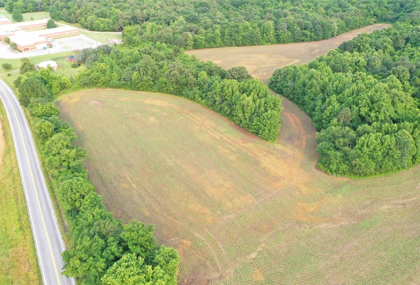 Aerial view of property's location with a heavily wooded area