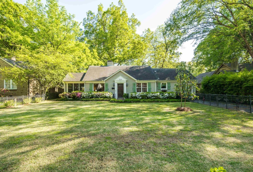 Ranch-style home with a chimney, fence, and a front yard