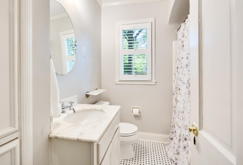 Bathroom featuring crown molding, tile patterned floors, vanity, baseboards, and toilet
