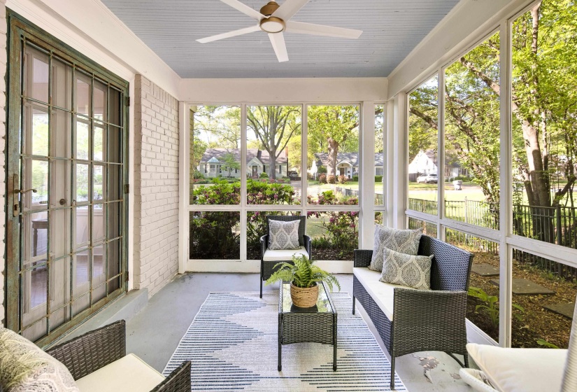 Sunroom / solarium featuring a healthy amount of sunlight, ceiling fan, and french doors