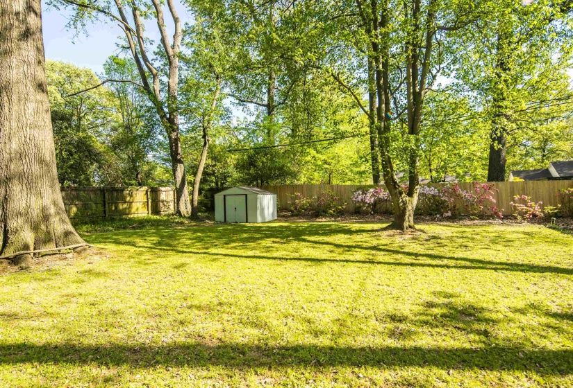 View of yard with an outdoor structure, a shed, and a fenced backyard