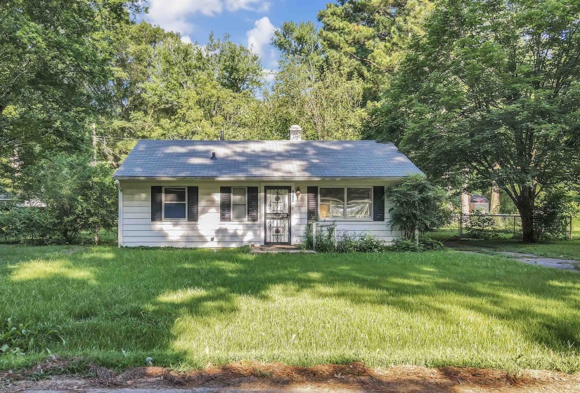 Single story home featuring a front yard and a chimney