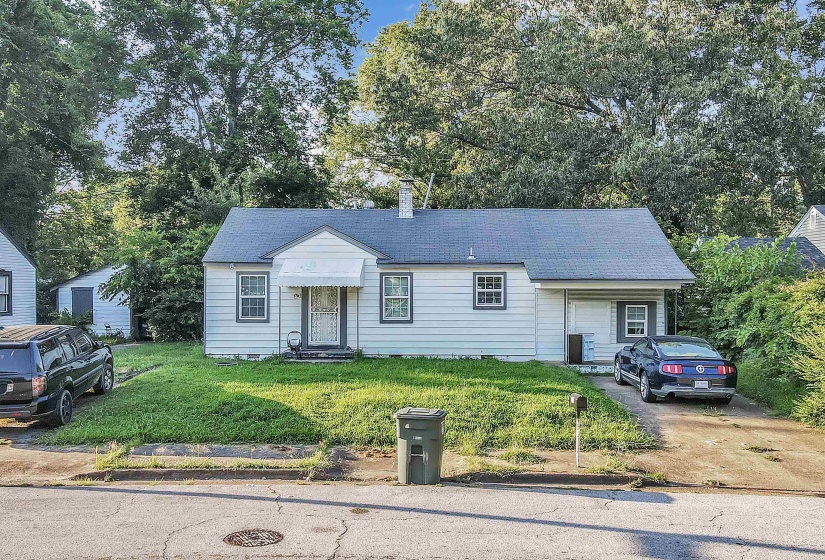 View of front of home with a front yard and entry steps